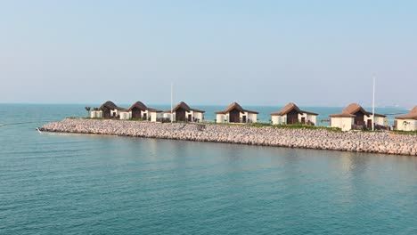 Overwater-villas,-huts-at-the-coastline-of-Ras-Al-Khaimah-in-the-United-Arab-Emirates