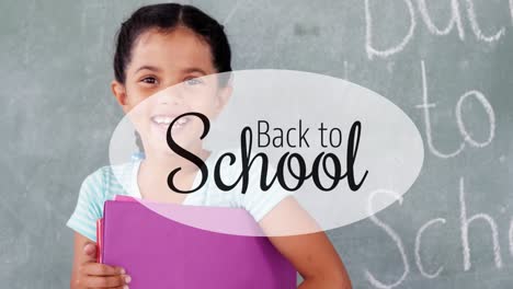 This-is-a-portrait-of-a-smiling-schoolgirl-holding-a-file-against-a-chalkboard