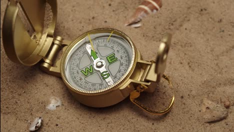 throwing gold compass on sand background close-up, golden compass. traveling and tourism concept, navigation