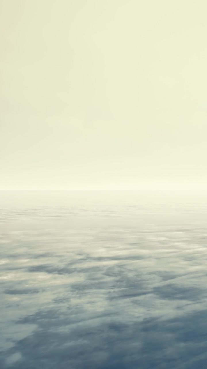 Wide view of a calm ocean at dusk under a cloudy sky