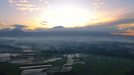 Luftaufnahme-Einer-Ländlichen-Landschaft-Mit-Bergkette-Im-Hintergrund-Bei-Sonnenaufgang