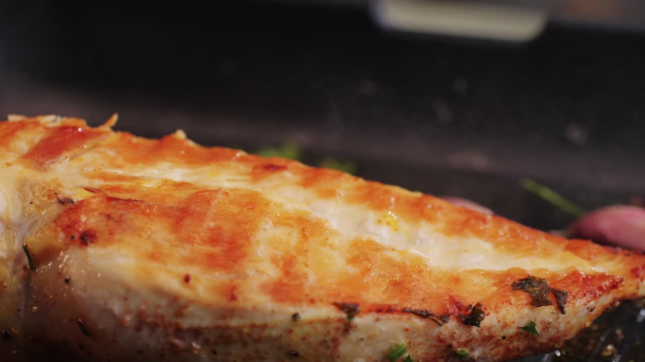 Cooking raw chicken meat in yellow turmeric spice with garlic and greens on grill close-up. Fry chicken slice on frying.pan Grilled chicken, duck, turkey kebab with vegetables.