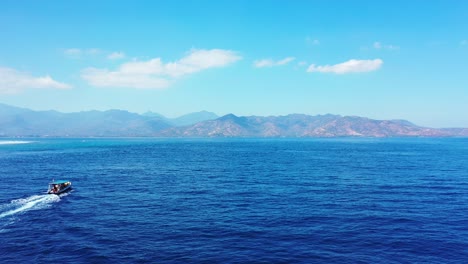 a stunning scenery of a speed boat in indonesia under the bright blue sky above - wide shot