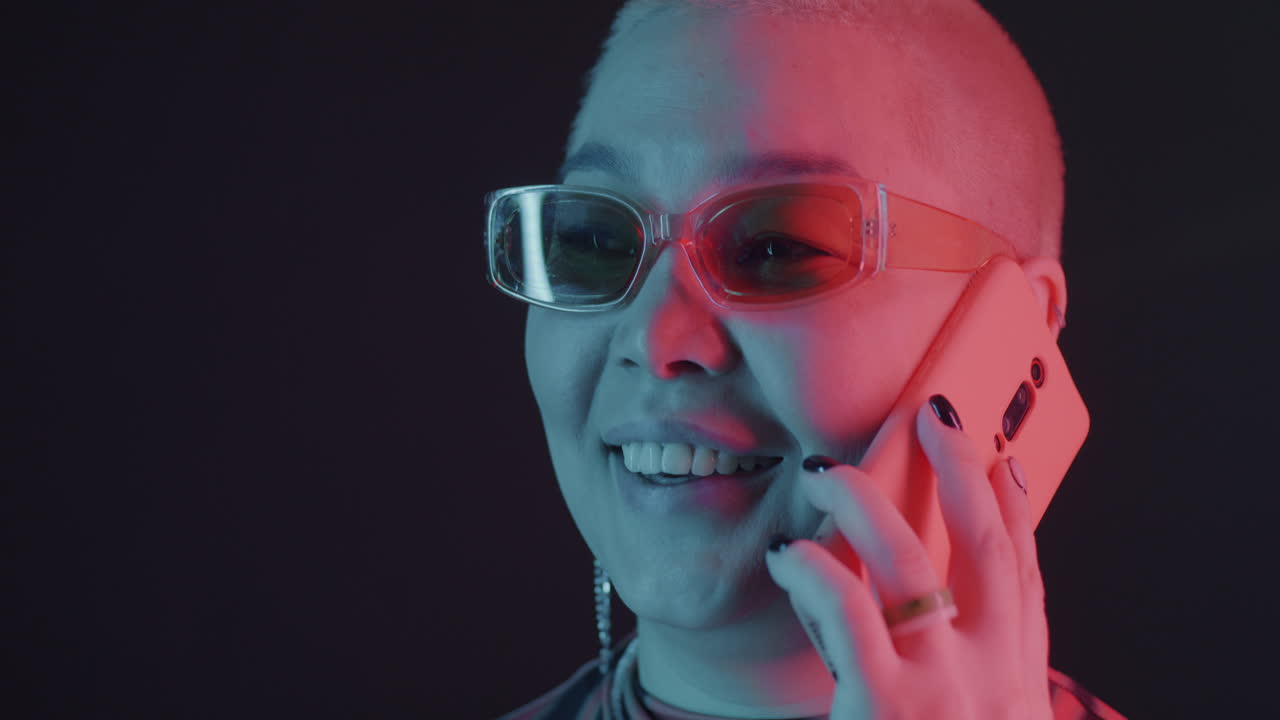 Stylish Woman Talking on Phone with Neon Lighting