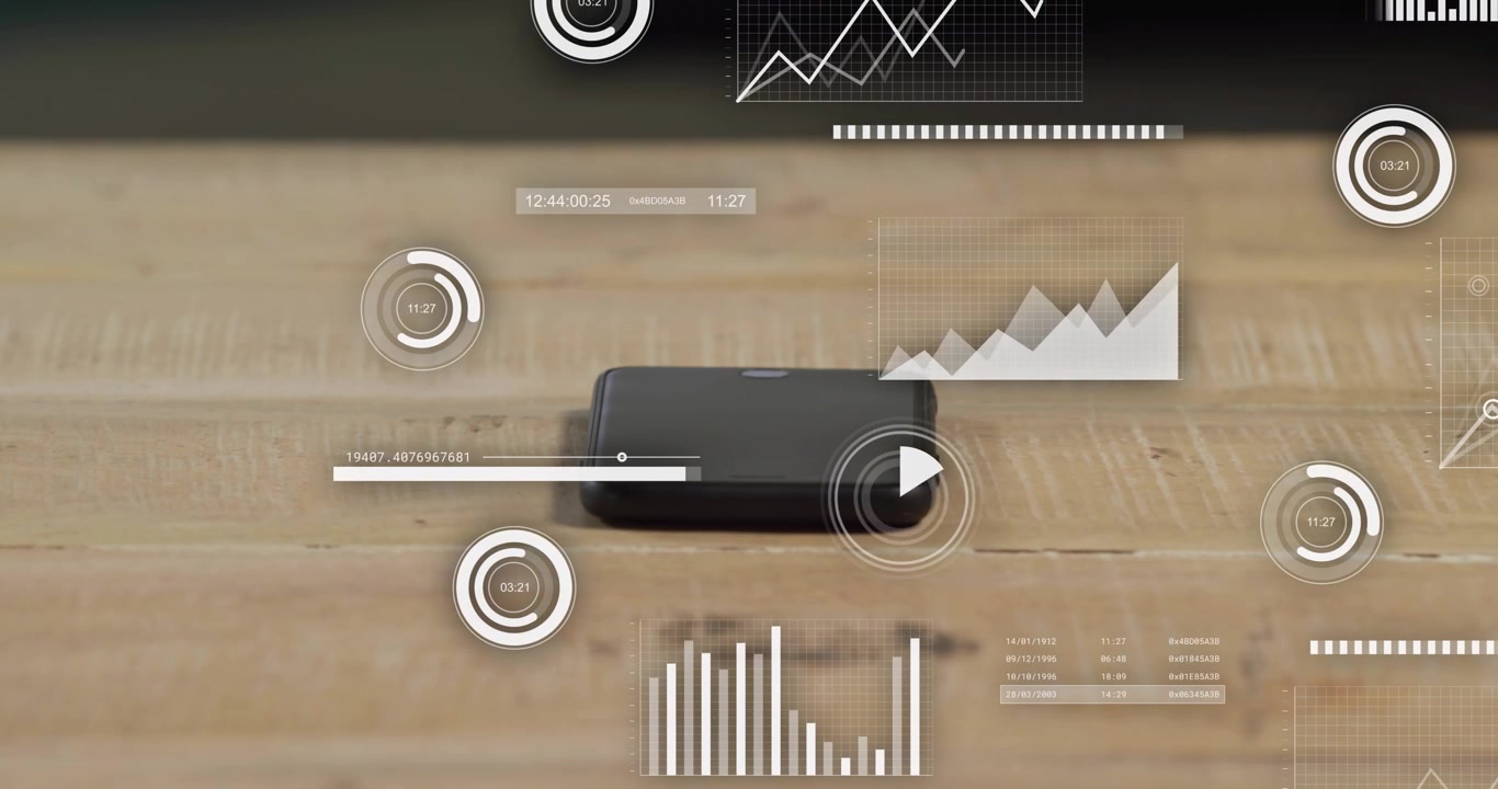 HUD elements emerging around black device on tabletop, visualizing metrics via timers rising graphs