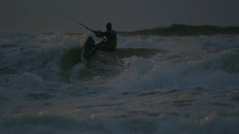 in rays of setting sun, kitesurfer enjoys freedom and excitement of kiteboarding, feeling rush of adrenaline with every movement