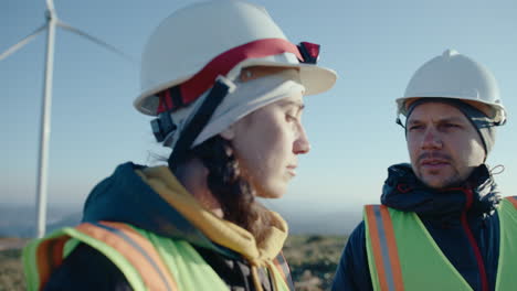 male and female wind farm engineers having conversation