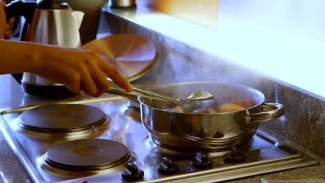 Women-papering-food-in-kitchen-at-home-4k