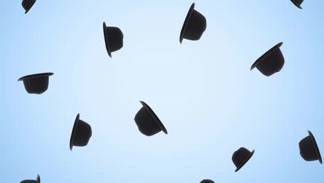 animation of black hats falling on blue background