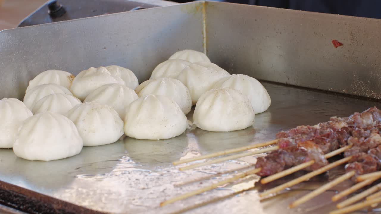 Cooking asian baozi with meat on desk close -up. Steaming Technique.. Street food Chinese and Korean pyanse, fast street food local festival