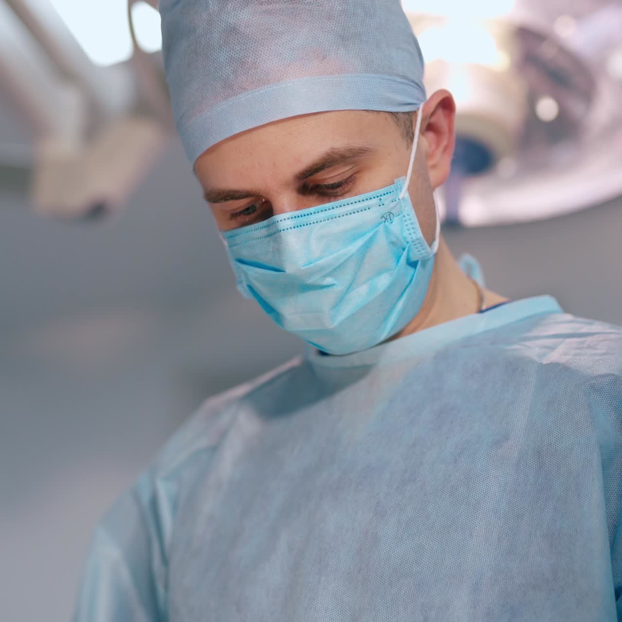Doctor man and a nurse in medical masks. Professional surgeon performing an operation in the hospital. Healthcare concept.