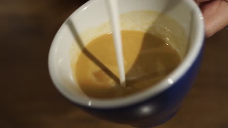 SLOWMO---Professional-female-barista-makes-rosetta-in-cappuccino---close-up