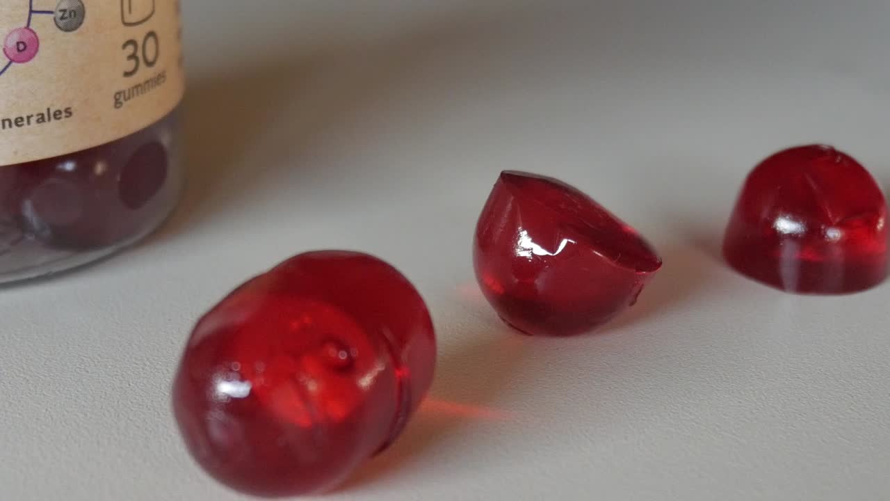 Close-up of red multivitamin gummies for health and wellness focus