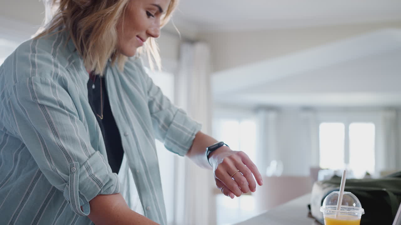 Casually Dressed Woman Downloading Data From Personal Health Tracker To Laptop At Home
