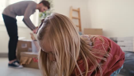 caucasian family packing kitchen stuff in new house.