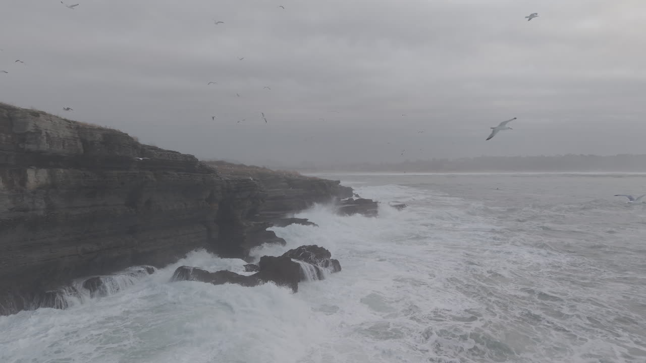 Dramatic Ocean Waves Crashing Against Rocky Cliffs on a Moody Day ...