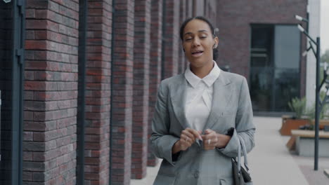 businesswoman walking outside office building