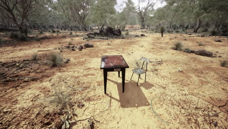 empty table and chair set in arid australian landscape under bright sun