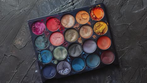 colorful makeup palette on textured background