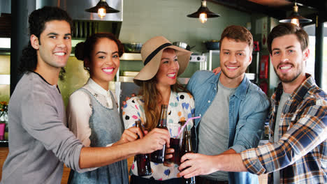 Friends-toasting-drinks-together-in-restaurant