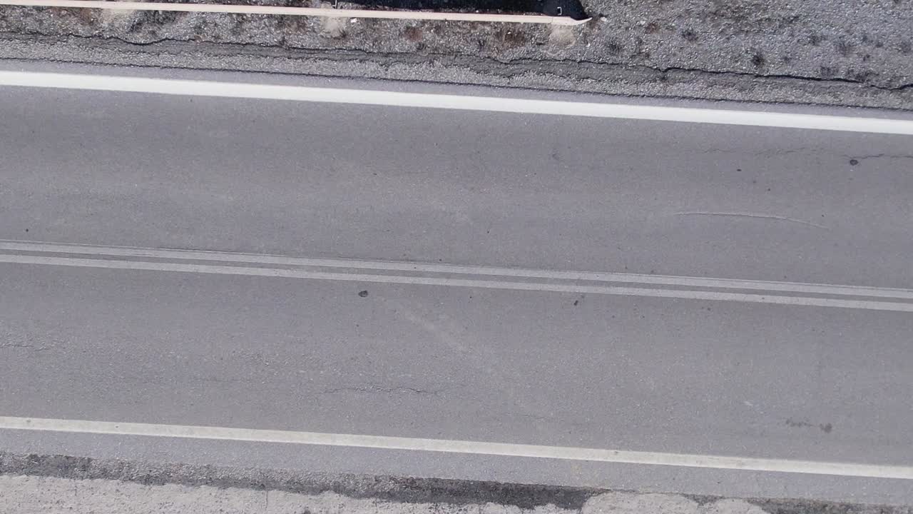 Aerial view of a deserted road in Greece under bright sunlight