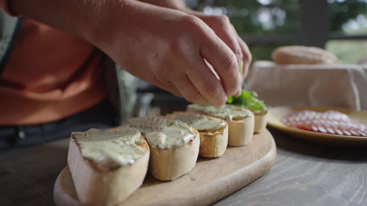 Adding Arugula Leaves to Bruschettas
