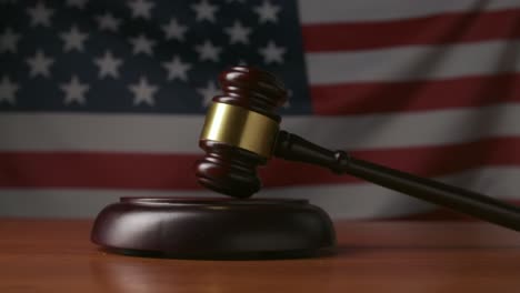 judge's gavel in front of the american flag