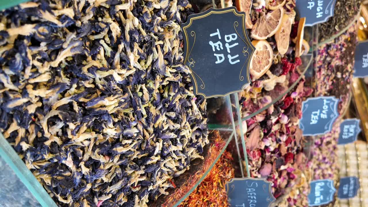 Close-up of various dried teas and herbal blends displayed in a market