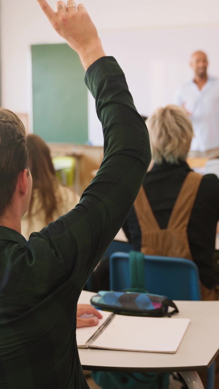 Student Raising Hand During Classroom Lecture