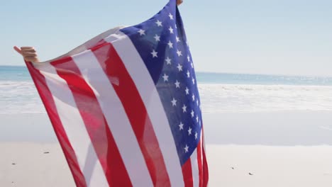 young woman dancing with flag on the beach 4k