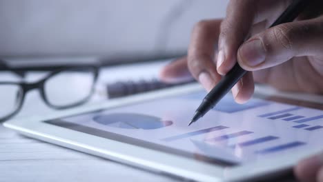 person analyzing data on a tablet