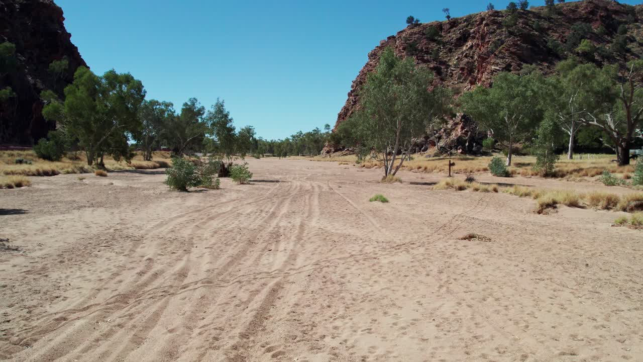 Drone footage moving forward along the Todd RIver towards Heavitree Gap, Alice Springs, Mparntwe. Northern Territory, Australia. August 2022.