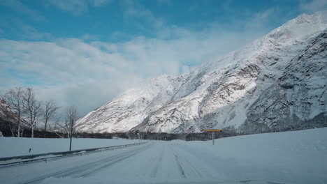 POV-driving-footage-on-snowy-mountain-roads-during-winter