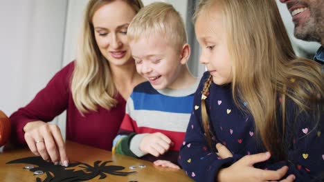 Handheld-video-of-happy-family-preparing-decoration-for-Halloween