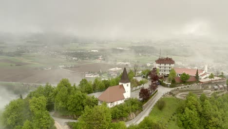 misty mountain village with church