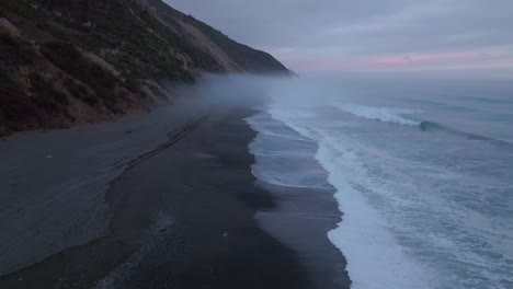 usal beach landscape scene sinkyone wilderness lost coast trail california aerial drone rugged untouched coastline black sand pacific ocean mist sunset cloudy untouched waves crashing forward