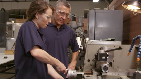 engineer training female apprentice on lathe shot on r3d