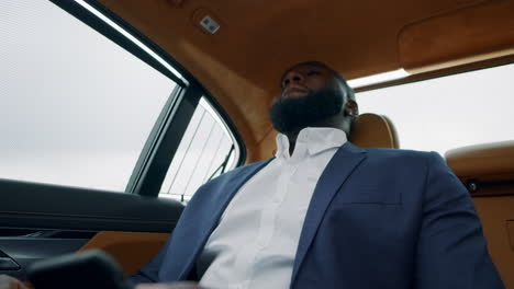 African-businessman-getting-bad-news-on-phone.-Depressred-man-at-luxury-car