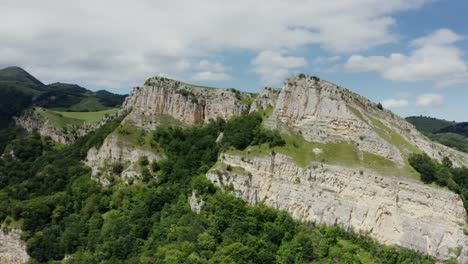 mountainous landscape with cliffs and forest