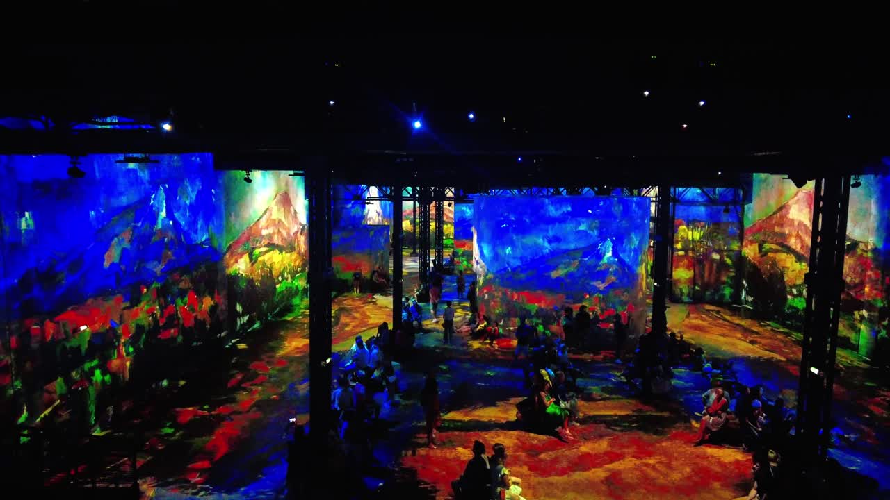 Tourists Inside The L'Atelier des Lumières Museum Showing The Cezanne, Lights of Provence By Gianfranco Iannuzzi In Paris, France. - POV