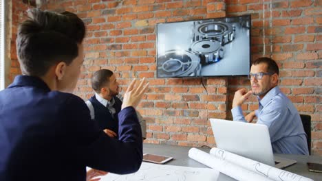 Executives-discussing-over-screen-in-conference-room-4k