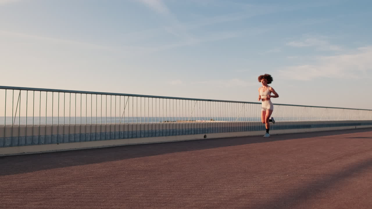 Young Woman Running By The Sea