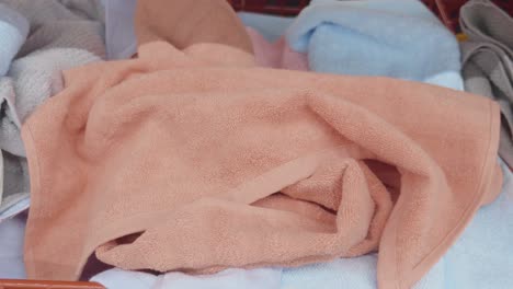 pile of folded towels in a basket