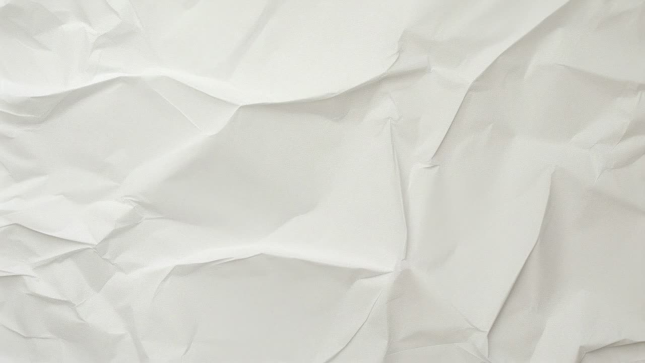 Aerial view of crumpled white paper, resembling abstract art