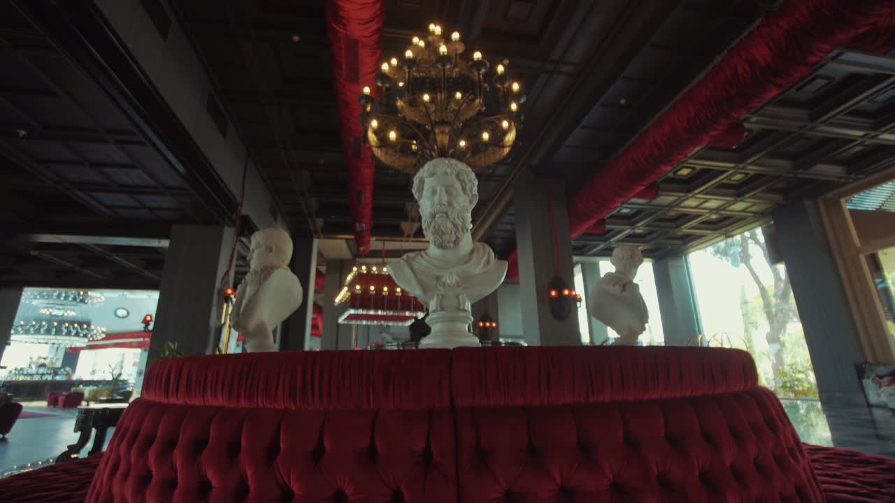 A detail from the hotel's stylish lobby. sculptures and red velvets. interior decoration of the hotel.