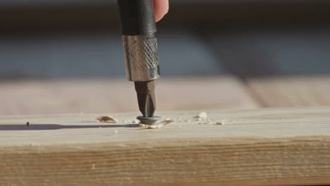 screw being driven into lumber with slipping drill bit, close, slow motion