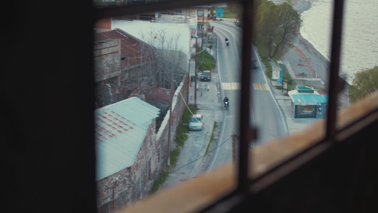 Traffic passing by derelict building window view