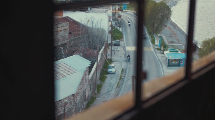 Traffic passing by derelict building window view