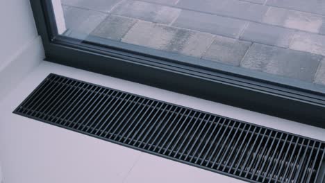 protective radiator grille built into the floor for heating panoramic windows. heating grid with ventilation by the floor in hardwood flooring