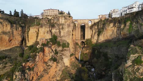 ronda arch bridge, waterfall and cityscape in malaga, andalusia, spain - aerial